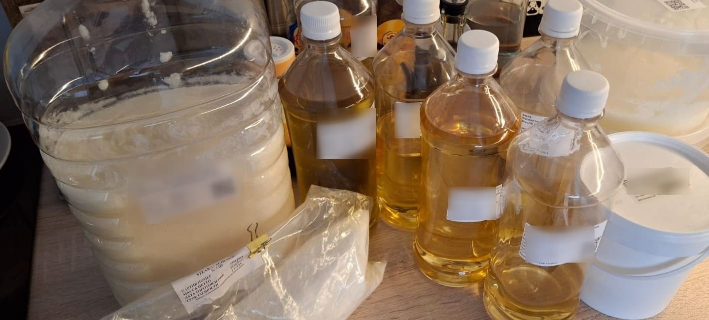 Measured liquid oils and solid ingredients prepared for small-batch natural soap production.